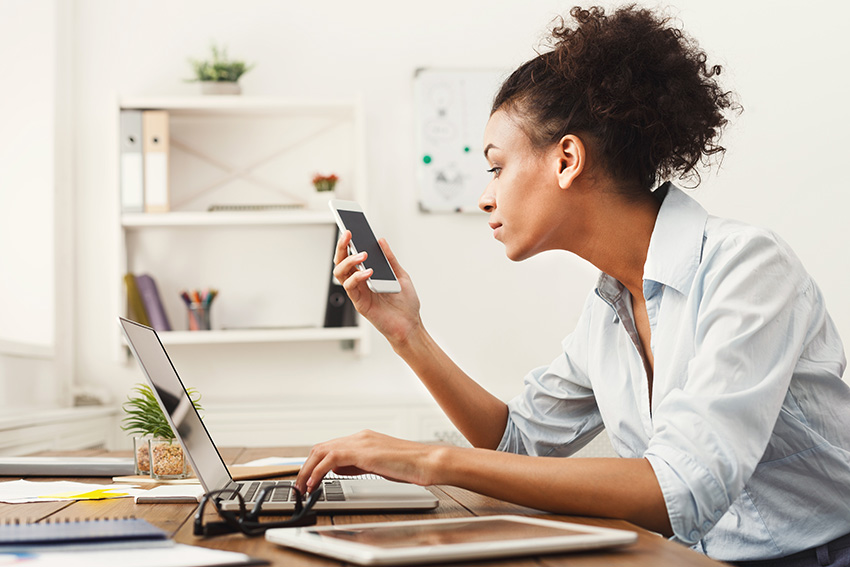 business woman looking at smartphone PQREEL