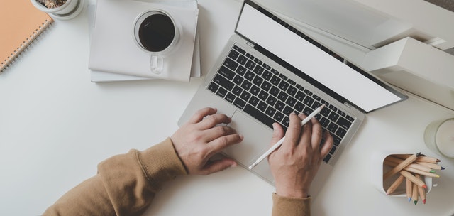 working man is typing on black frame laptop