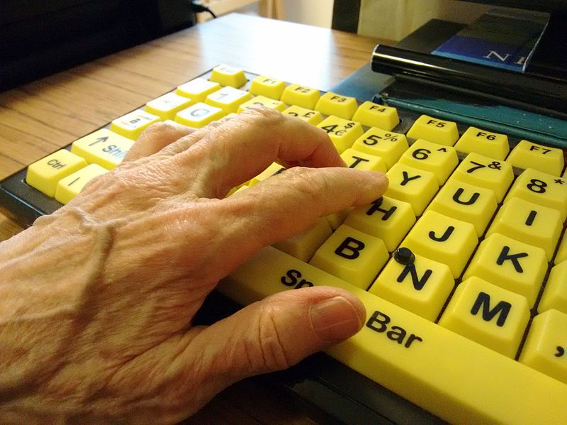 Hand on high contrast accessible computer keyboard