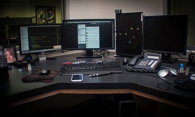 A modern workspace for a front-end web developer with CSS interview preparations, showcasing a laptop, books, and motivational elements.
